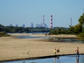 Family playing over WisÃâa. City of Warsaw in the background.